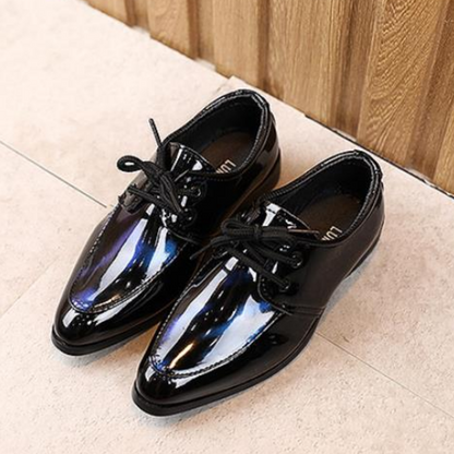 Kids' special occasion shoes, black leather slip-ons with a sleek pointy toe design