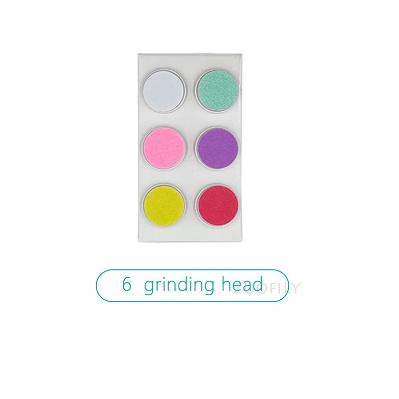 Detail shot of the grinding head on a silent electric baby nail trimmer, dinosaur egg cover