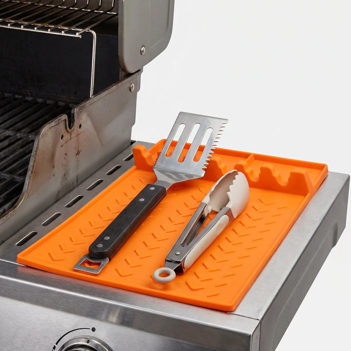 Kitchen utensil rest and spoon holder, a silicone mat organizer for cooking tools on countertops.