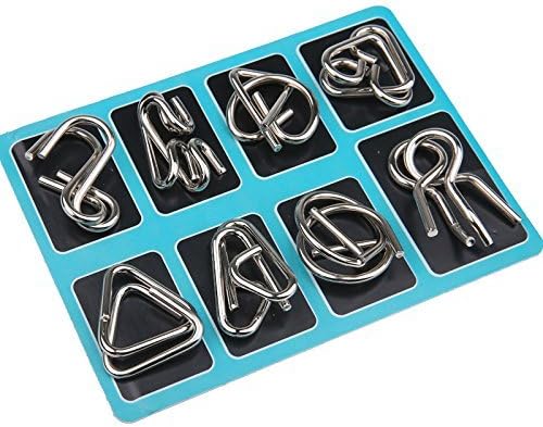 Brain teaser metal puzzle rings on a wooden table, inviting a challenging logic game