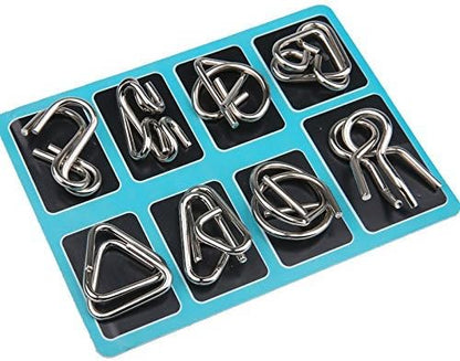 Brain teaser metal puzzle rings on a wooden table, inviting a challenging logic game