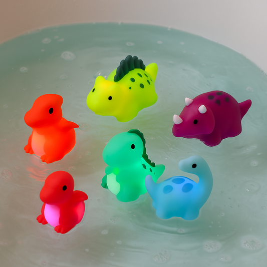 Six colorful light-up dinosaur bath toys in water, glowing playfully for kids' bath time fun