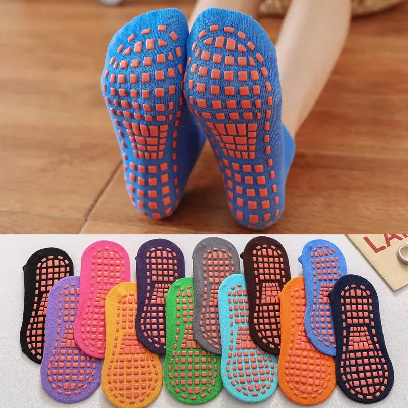 Six pairs of colorful anti-slip trampoline socks for kids and adults, with grip soles for indoor play.