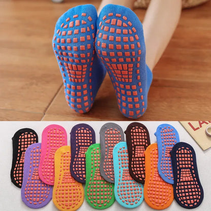 Six pairs of colorful anti-slip trampoline socks for kids and adults, with grip soles for indoor play.