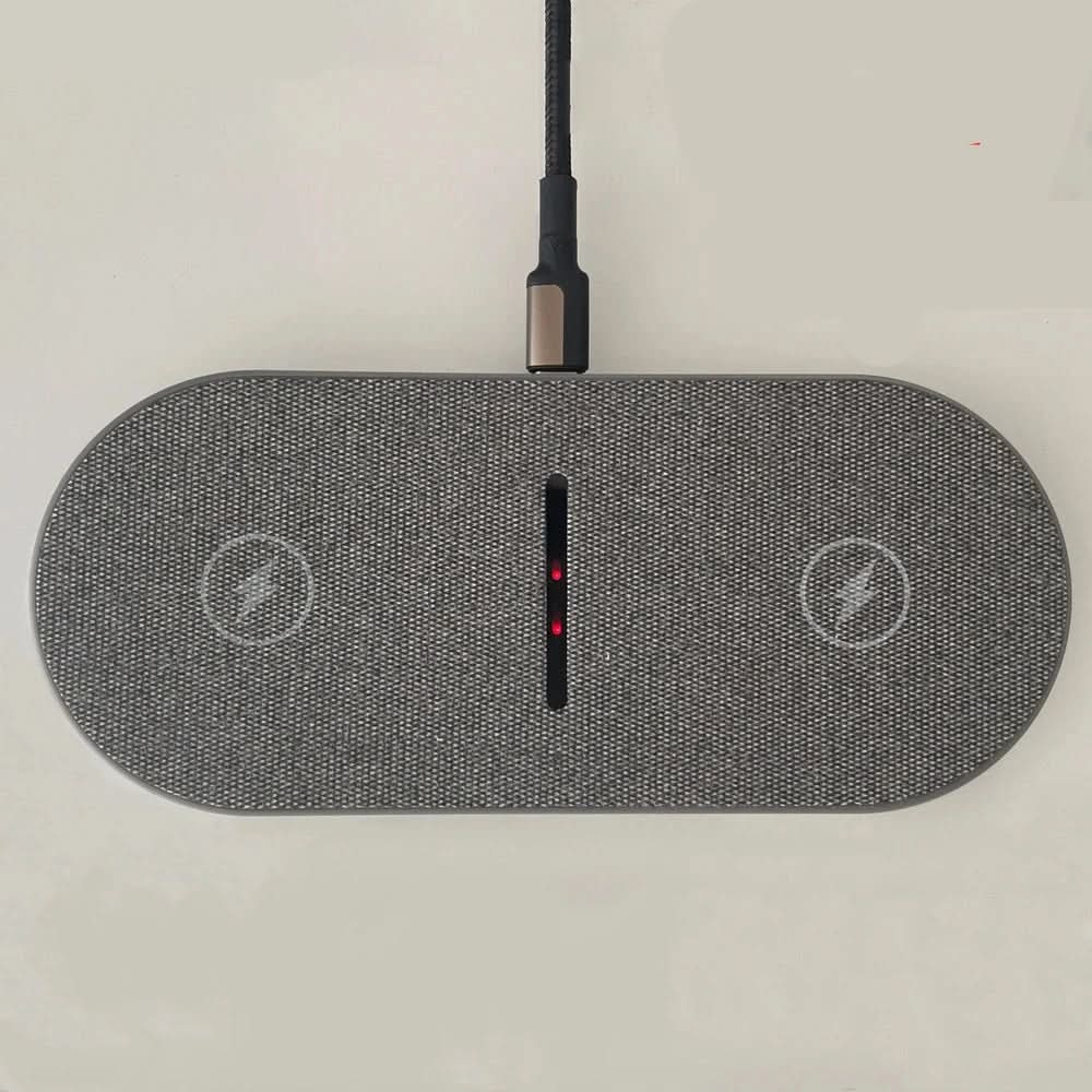 Close-up of the Qi-compatible fast wireless charging pad surface, showing dedicated charge zones for multiple devices.