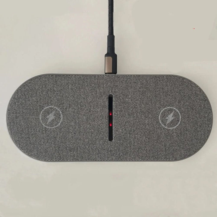 Close-up of the Qi-compatible fast wireless charging pad surface, showing dedicated charge zones for multiple devices.