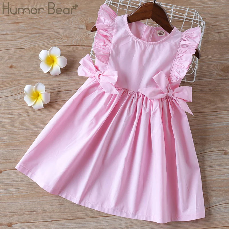 Detailed image of the fabric and big bow on a girls' summer party dress