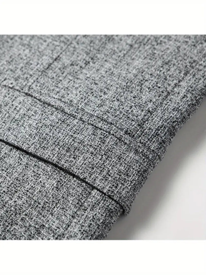 Close-up of a men's spring blazer with refined lapels and button details, emphasizing quality tailoring.