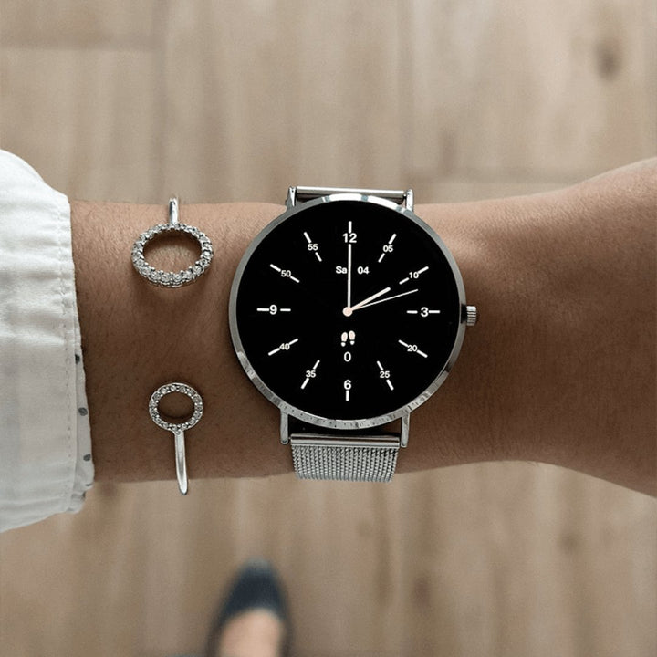 Women's slim fitness tracker smartwatch in rose gold, monitoring activity & workouts with style.
