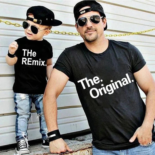 Smiling father and son in matching gray t-shirts with 'The Original' & 'The Remix' text, casual summer wear.