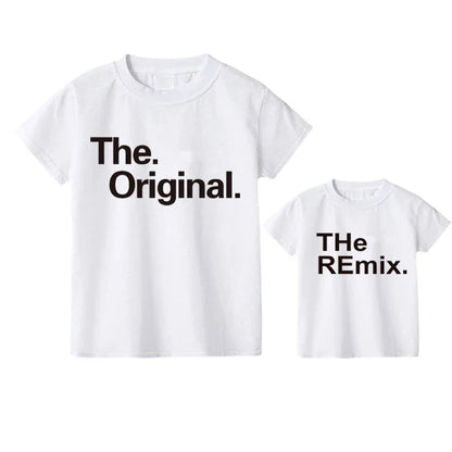 Lifestyle image of dad and son playing in a park, wearing their comfy matching graphic t-shirts.