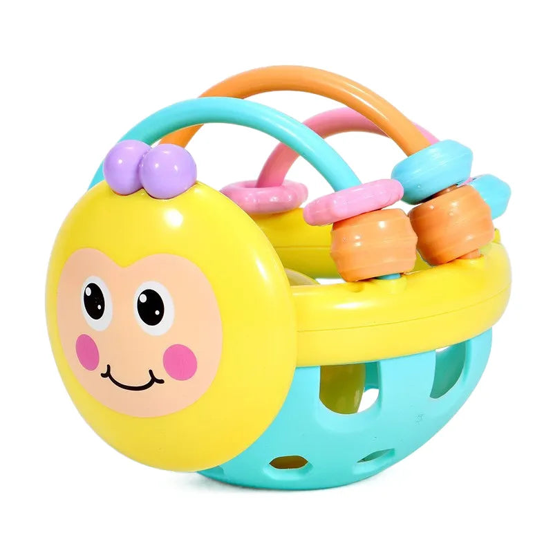 Close-up of a baby's hand grasping a soft sensory teether rattle ball, newborn developmental toy.