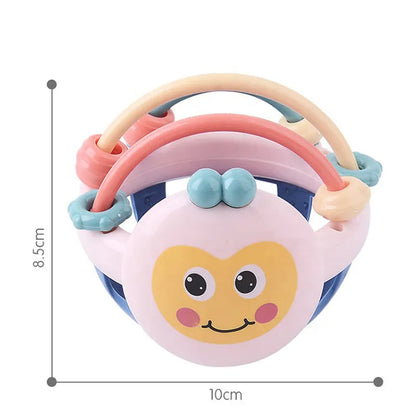 A newborn happily playing with a colorful, soft baby sensory teether rattle ball toy.