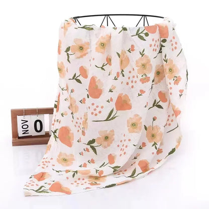 Bamboo cotton muslin swaddle acting as a discreet nursing cover for a mother and baby
