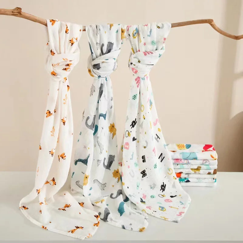 Newborn baby wrapped snugly in a soft bamboo cotton muslin swaddle blanket, peaceful