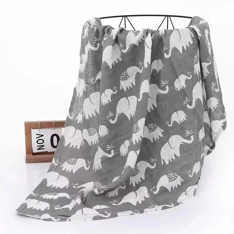 Two-layer bamboo cotton muslin swaddle blanket spread out, showcasing its generous size