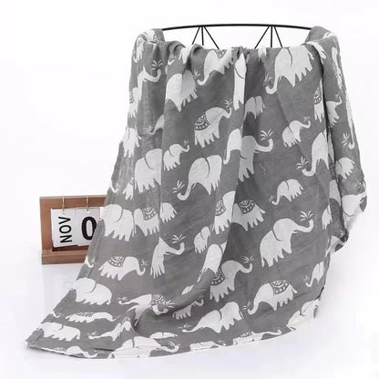 Two-layer bamboo cotton muslin swaddle blanket spread out, showcasing its generous size