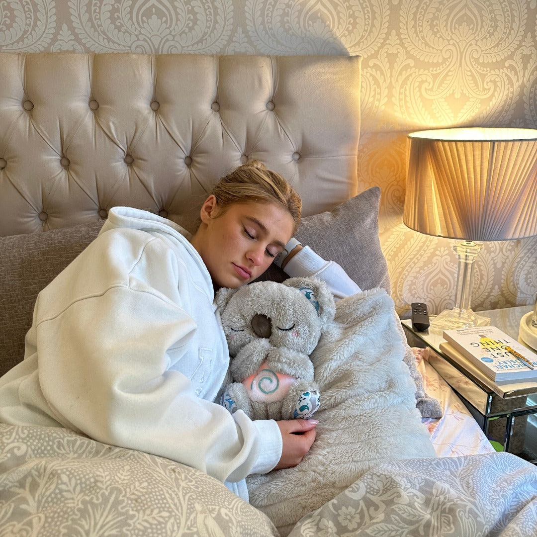 Soft Calming Koala breathing sleep aid toy, plush companion with gentle movements & night light for baby relaxation.
