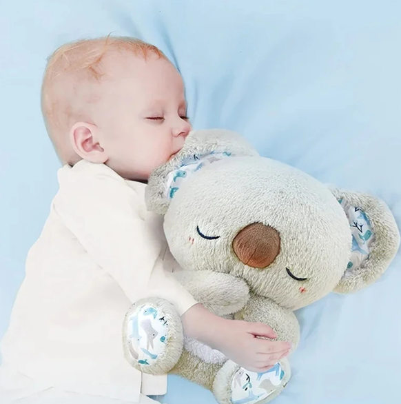 Plush Koala sleep aid with rhythmic breathing motion & soft glow night light, perfect for relaxation & anxiety relief.