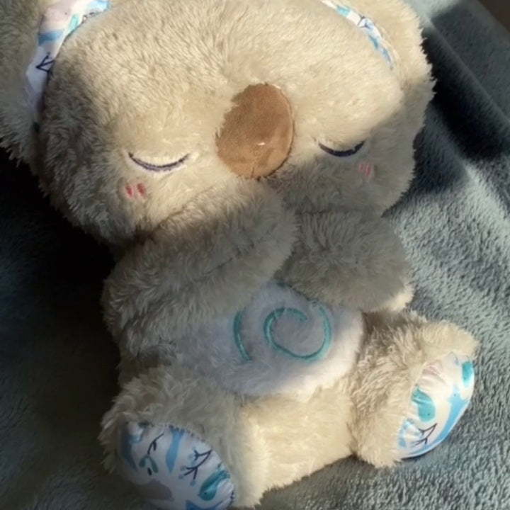 Interactive Koala sleep aid toy with breathing simulation, built-in night light for relaxation & better sleep.