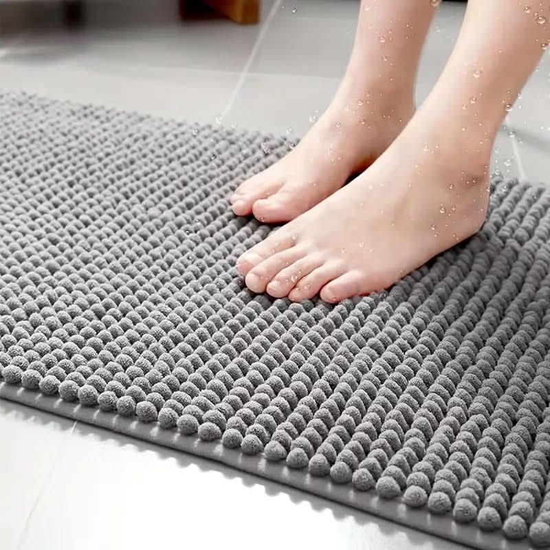 Stylish chenille bath rug enhances bathroom decor. Soft, absorbent, & non-slip floor mat for modern homes.