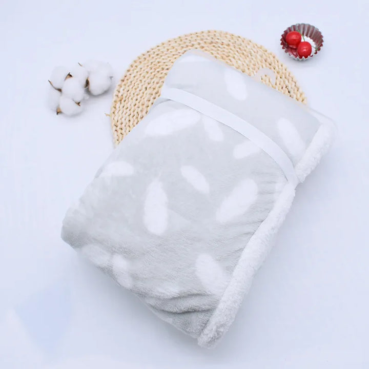 Luxurious coral fleece blanket, a cozy baby shower gift.