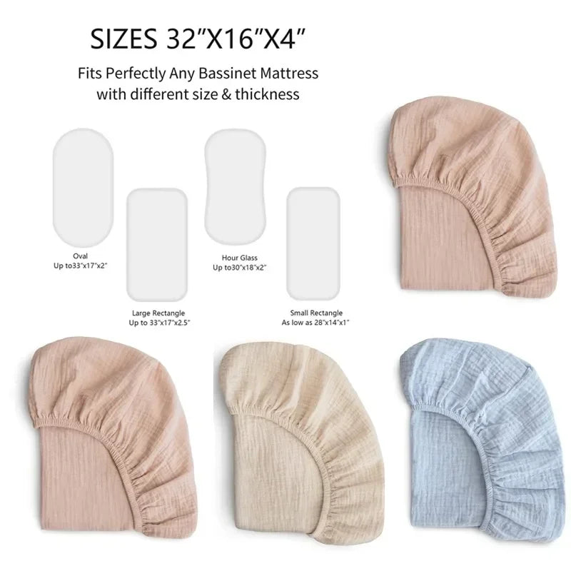 Overhead view of a baby's bassinet with a fitted white cotton sheet on the mattress