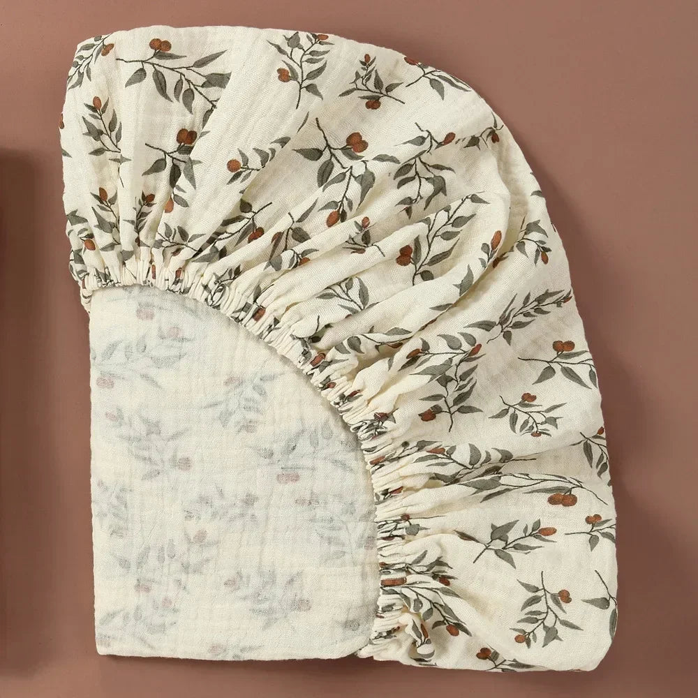 Stack of folded white cotton bassinet sheets, featuring soft texture and breathable fabric