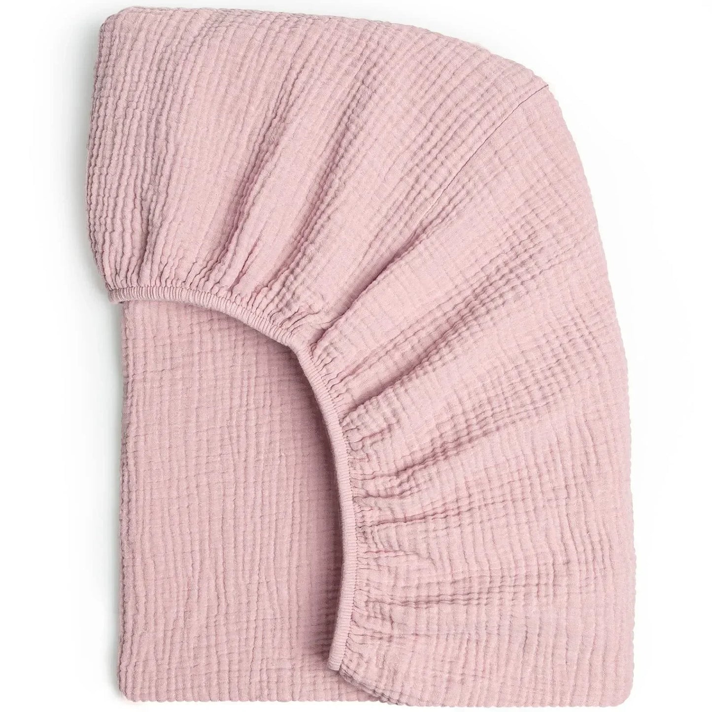 Detail of the elastic edge of a fitted cotton bassinet sheet, ensuring secure crib cover