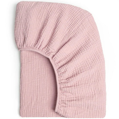 Detail of the elastic edge of a fitted cotton bassinet sheet, ensuring secure crib cover
