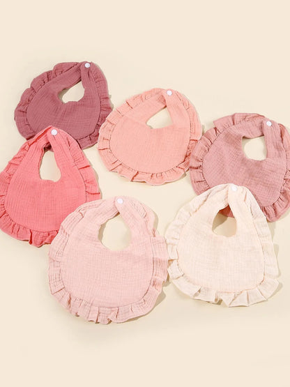 White cotton feeding bib for baby, featuring a playful design, perfect for learning to walk.