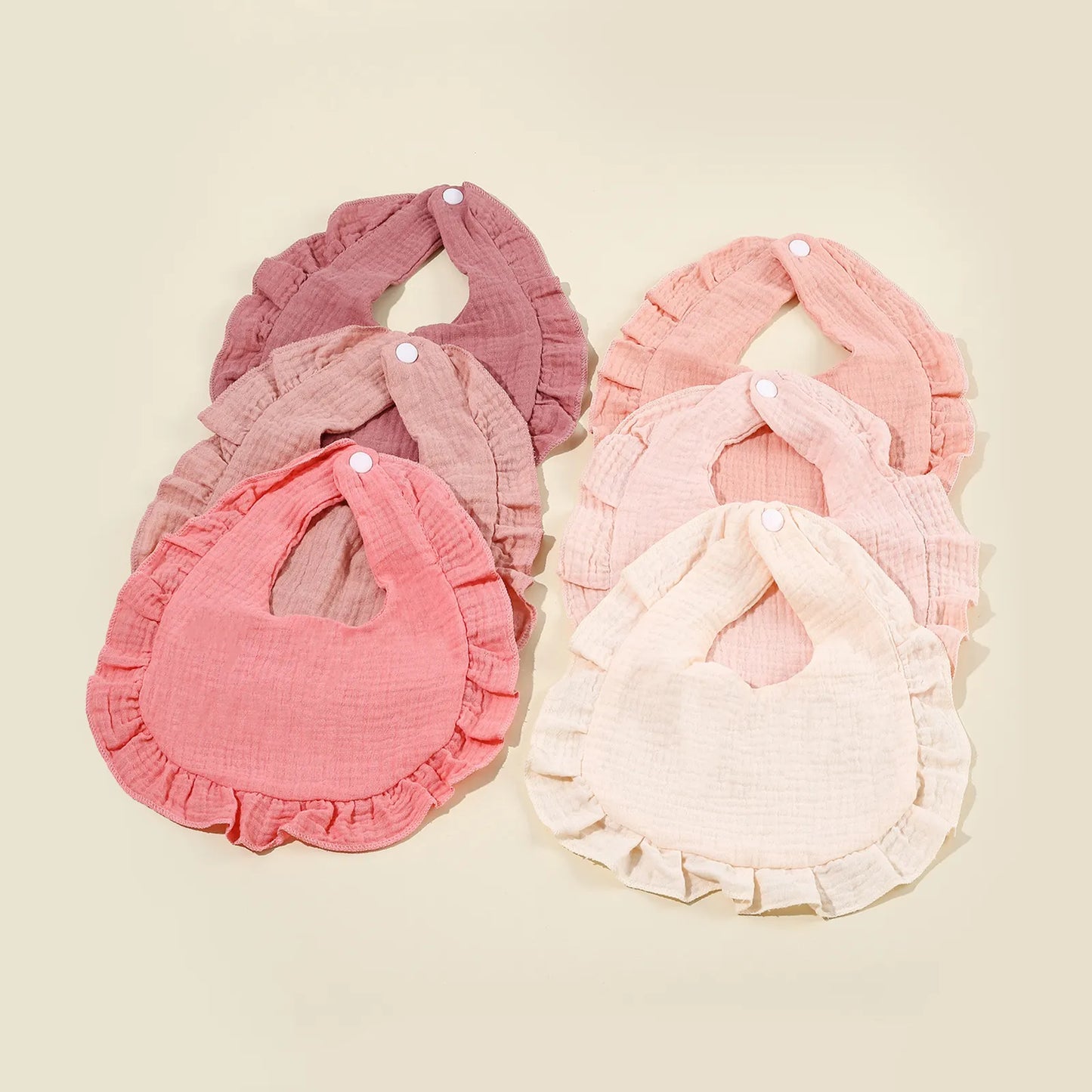 Toddler cotton bib in a neutral color, absorbent and soft, a must-have baby accessory for feeding.
