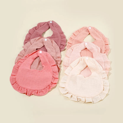 Toddler cotton bib in a neutral color, absorbent and soft, a must-have baby accessory for feeding.