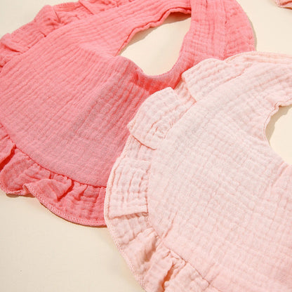 Close-up of a baby's cotton feeding bib, showcasing soft fabric texture, great for drool and meals.