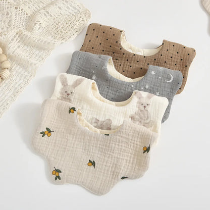 Soft cotton baby feeding bib with white and pink petal print, ideal for newborns & everyday dribble protection