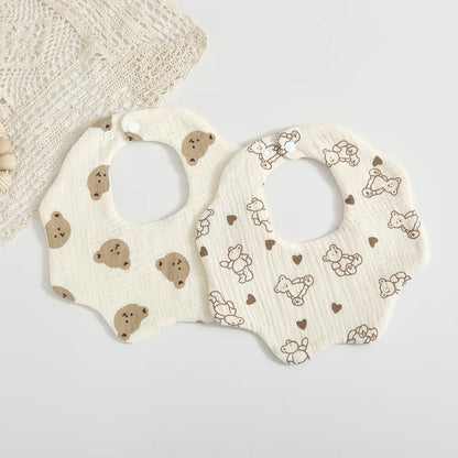 Close-up of a baby's cotton petal print feeding bib, showcasing the delicate fabric & absorbency, unisex design