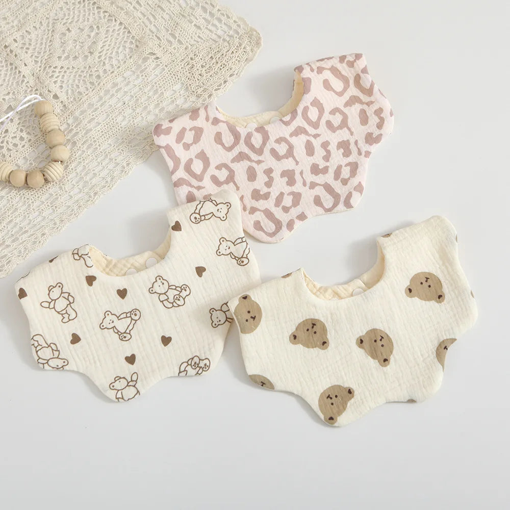 Stack of colorful baby cotton bibs featuring a charming petal print, perfect for baby shower gift sets
