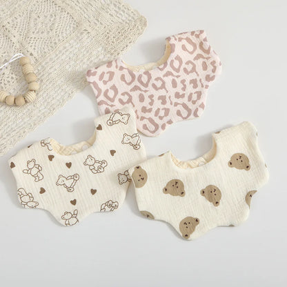 Stack of colorful baby cotton bibs featuring a charming petal print, perfect for baby shower gift sets