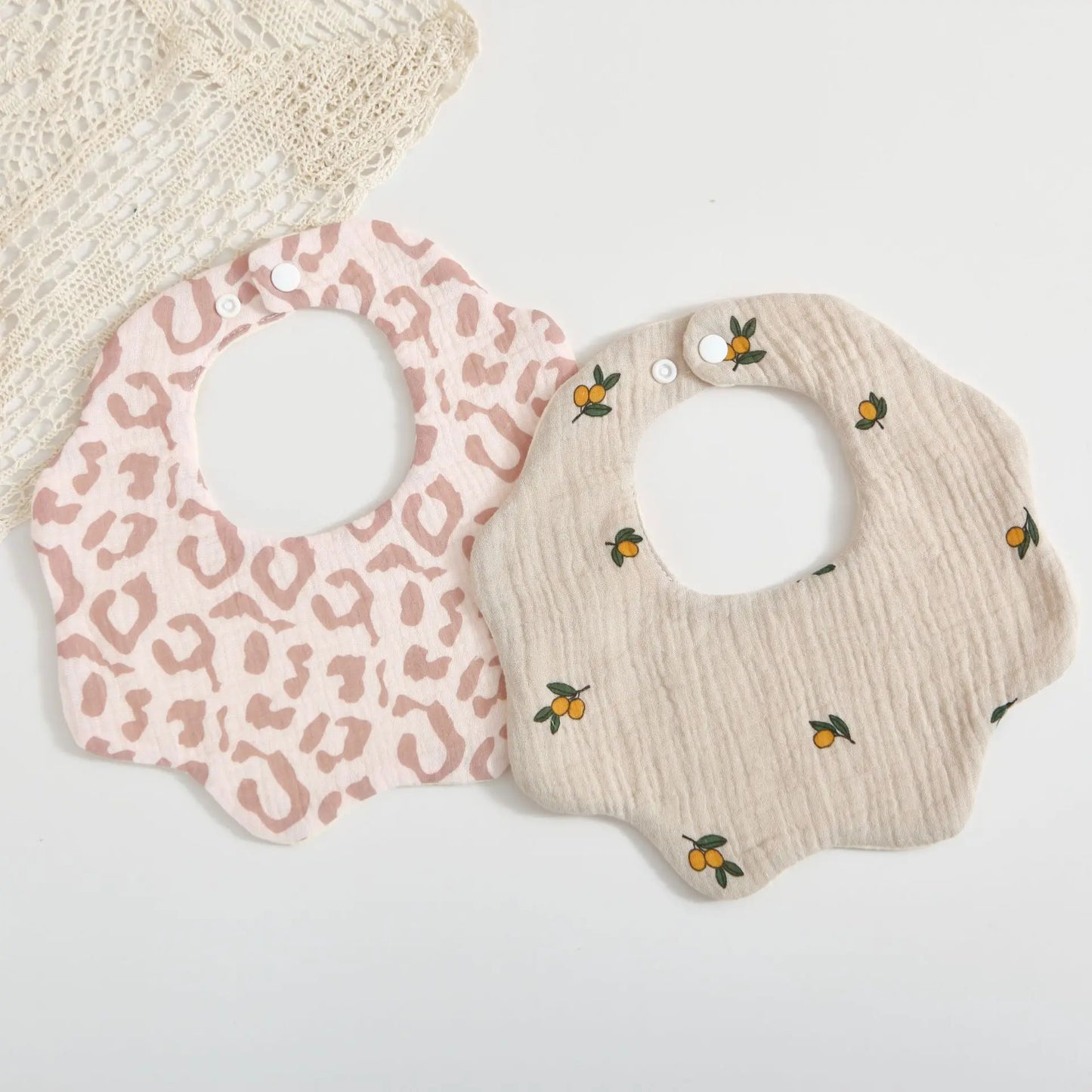Unisex baby feeding bib in soft cotton with an adorable petal print, essential for mealtime and burping
