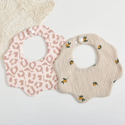 Unisex baby feeding bib in soft cotton with an adorable petal print, essential for mealtime and burping