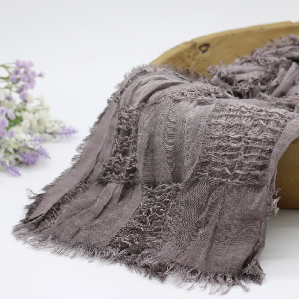 Newborn baby wrapped snugly in a soft cotton swaddle blanket