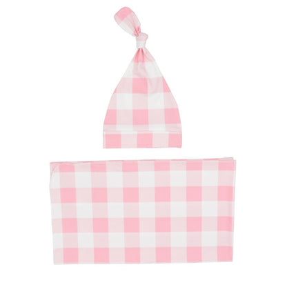 Close-up of a cozy plaid newborn swaddle blanket and baby hat, perfect for infant photography.