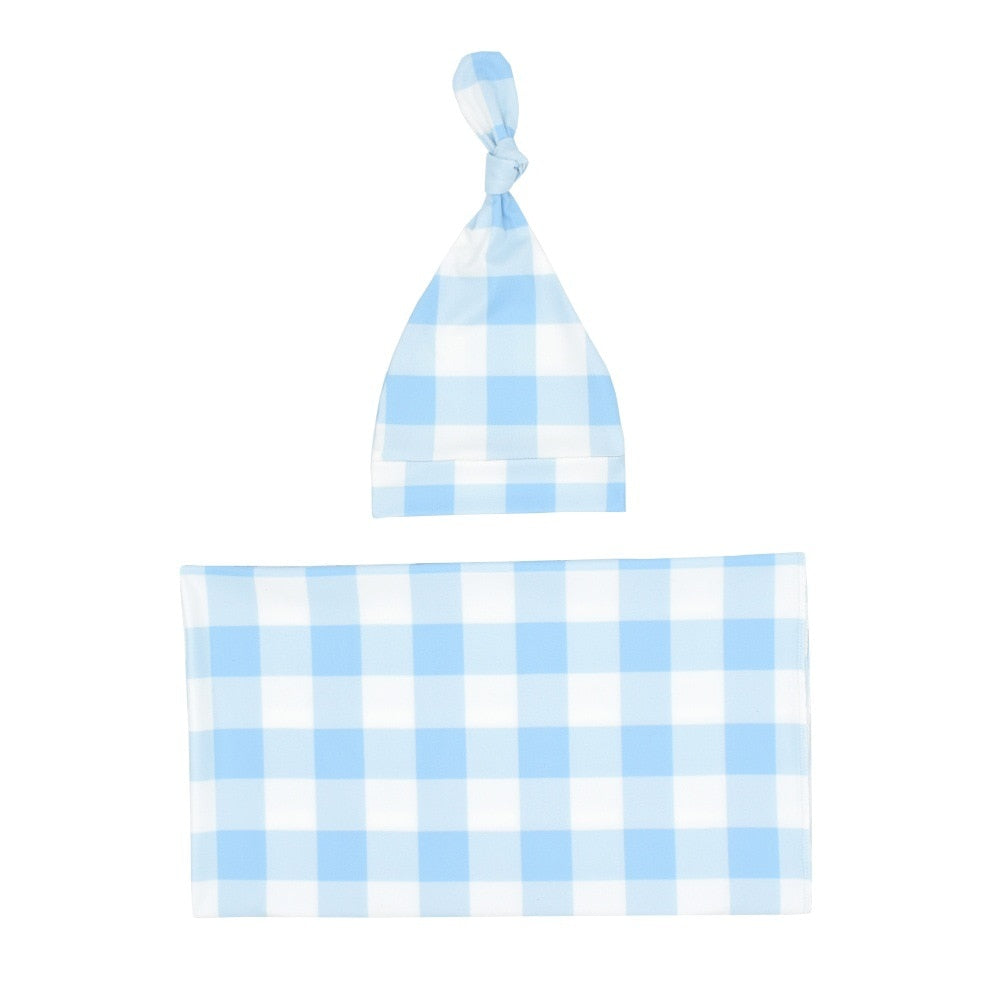 Two-piece nursery set: soft plaid baby blanket and matching beanie hat for newborn comfort.