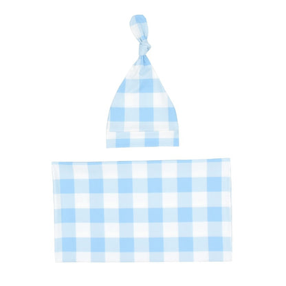 Two-piece nursery set: soft plaid baby blanket and matching beanie hat for newborn comfort.