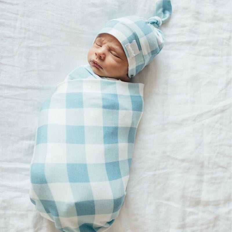 Infant plaid swaddle blanket & snug baby hat, made from breathable cotton blend fabric.