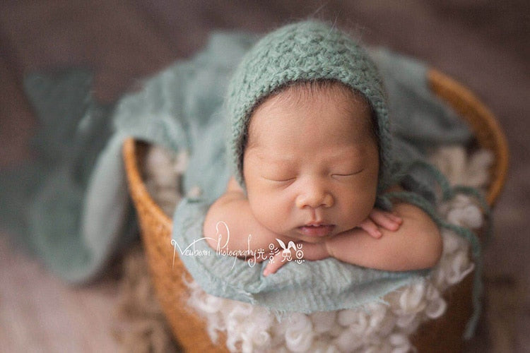 Comfy baby wrap, a versatile photography prop and soft blanket for newborn photo shoots.