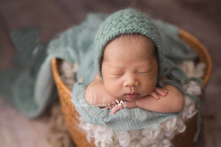 Comfy baby wrap, a versatile photography prop and soft blanket for newborn photo shoots.