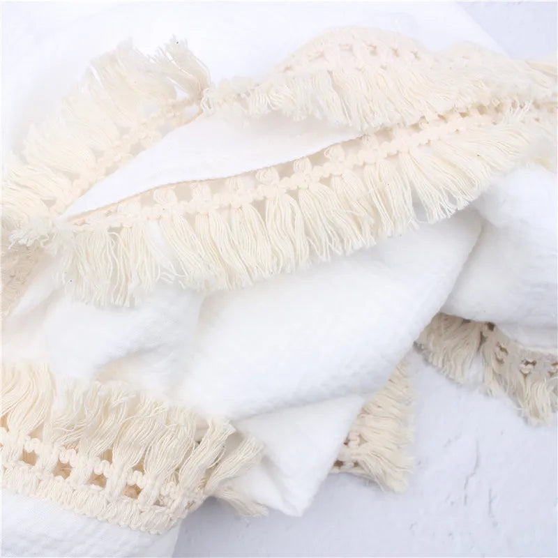Gentle cotton newborn swaddle wrap with delicate tassels, excellent for baby comfort and nursery decor
