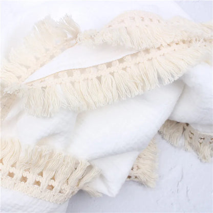 Gentle cotton newborn swaddle wrap with delicate tassels, excellent for baby comfort and nursery decor