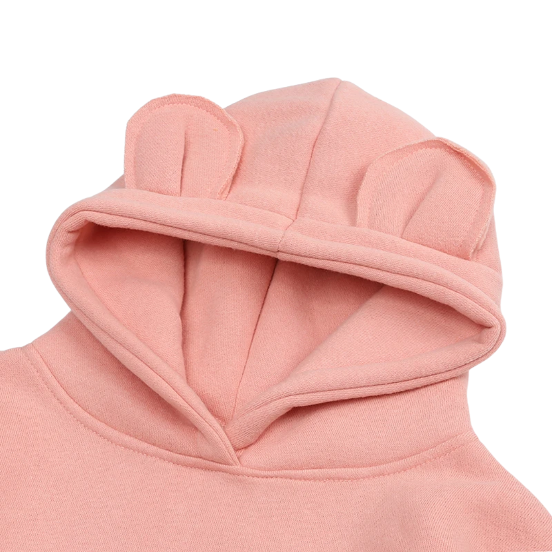 Close-up of a pink cotton kids cartoon ear hoodie showing soft fabric and ear detail, comfort apparel